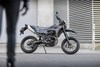 Side angle of a motorcycle staged on a city street.