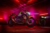Side angle of a motorcycle parked in a garage.