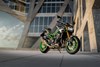 Three-quarter front angle of a motorcycle in front of an architectural building.